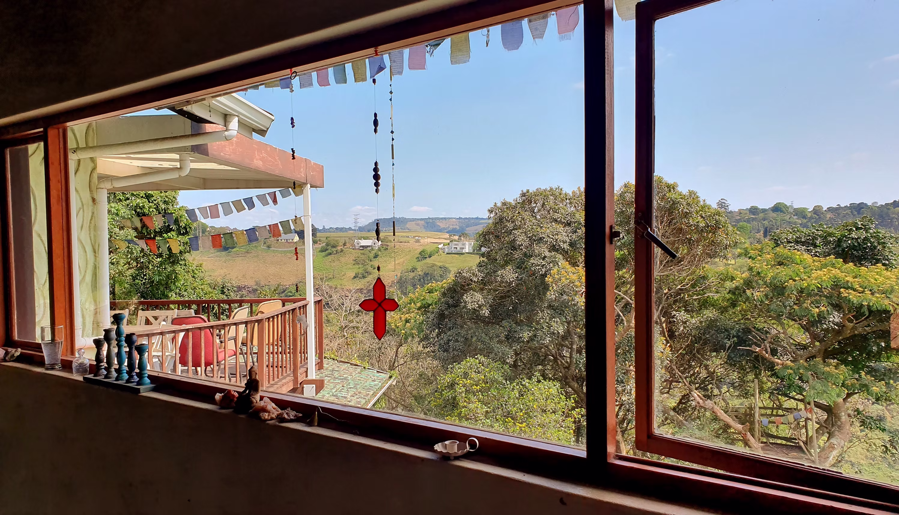 Panoramic window view from Eagles View Yoga studio overlooking the beautiful hills of Gillitts